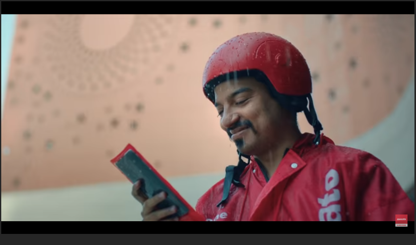 Delivery worker walks into the rain and accepts his next order. Zomato Ad/ Youtube